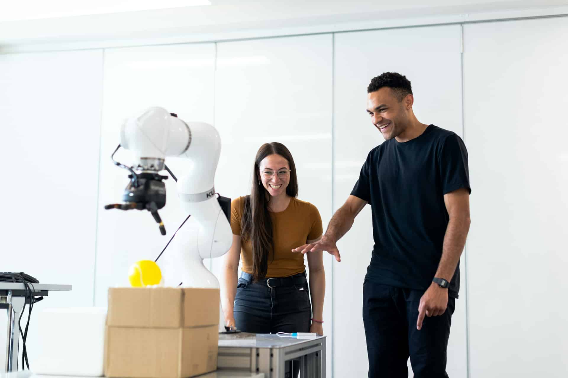 Engineers working with a collaborative robot arm